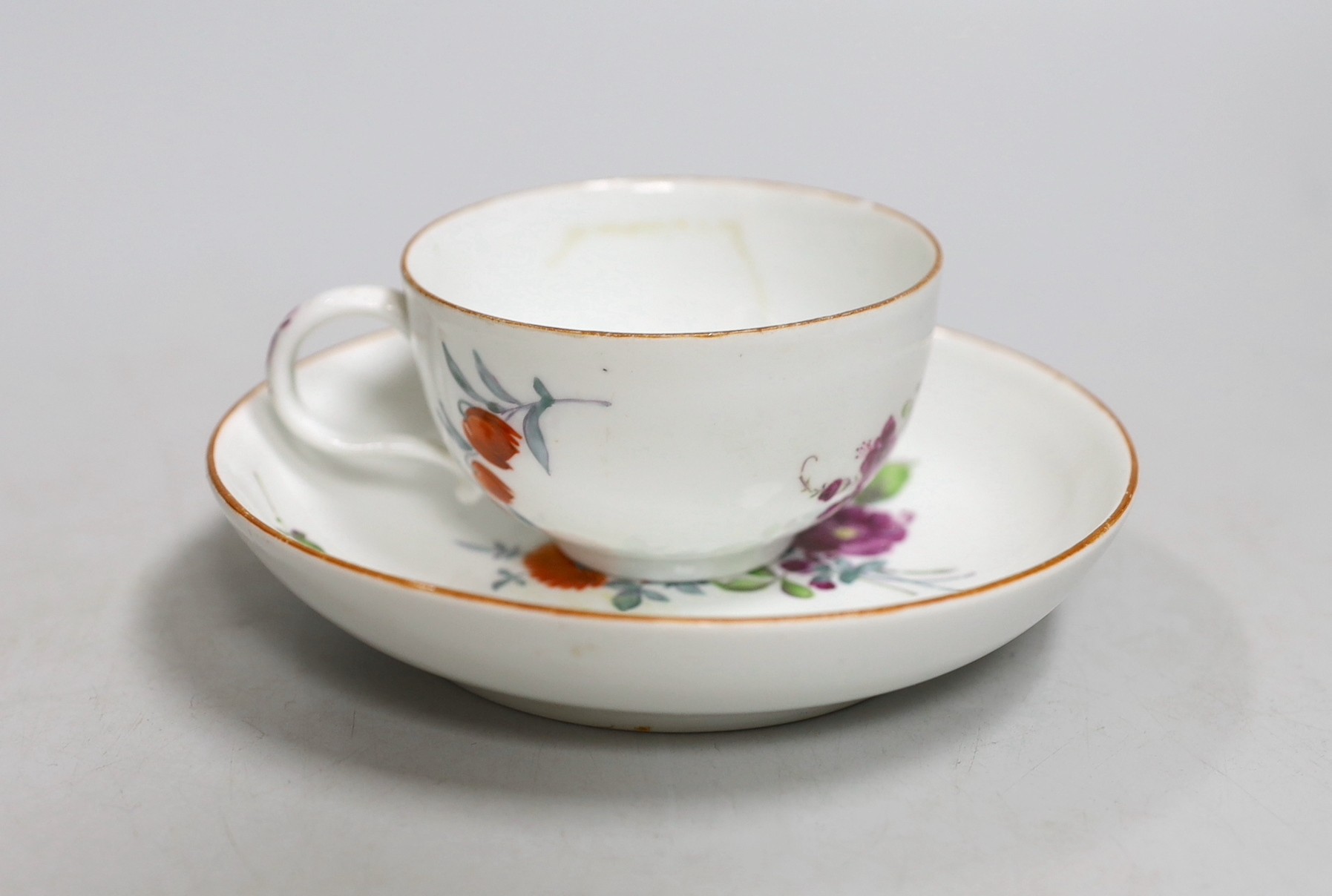 A Meissen dot period flower painted cup and saucer, c.1770